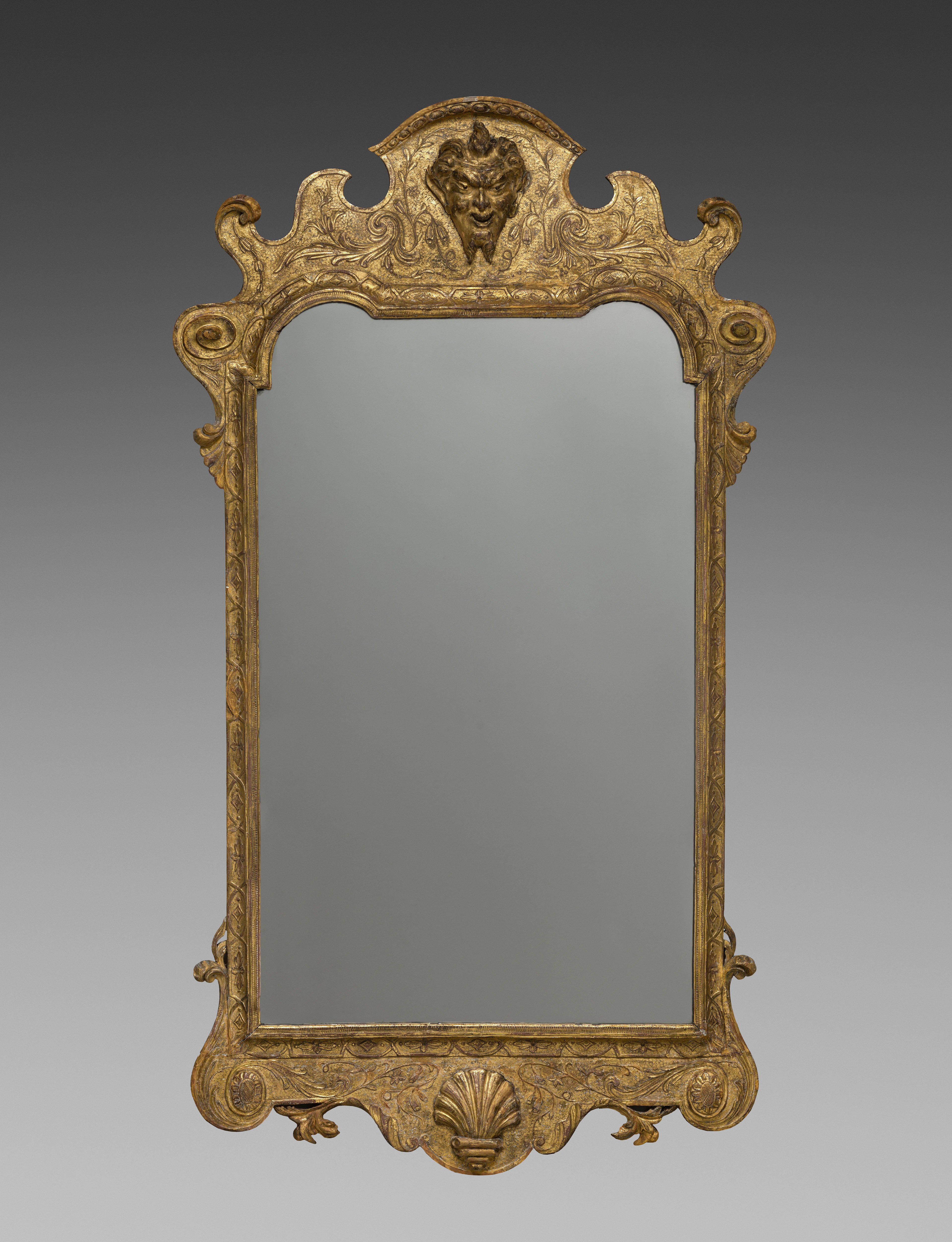 Ornate gilded mirror with carved details