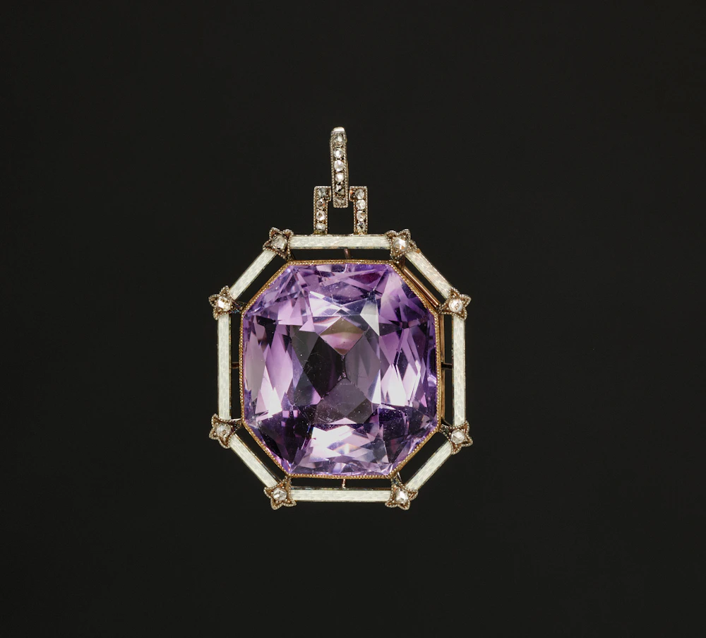 Faceted amethyst pendant in an ornate gold and diamond frame