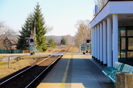 A bench sitting on the side of a train track