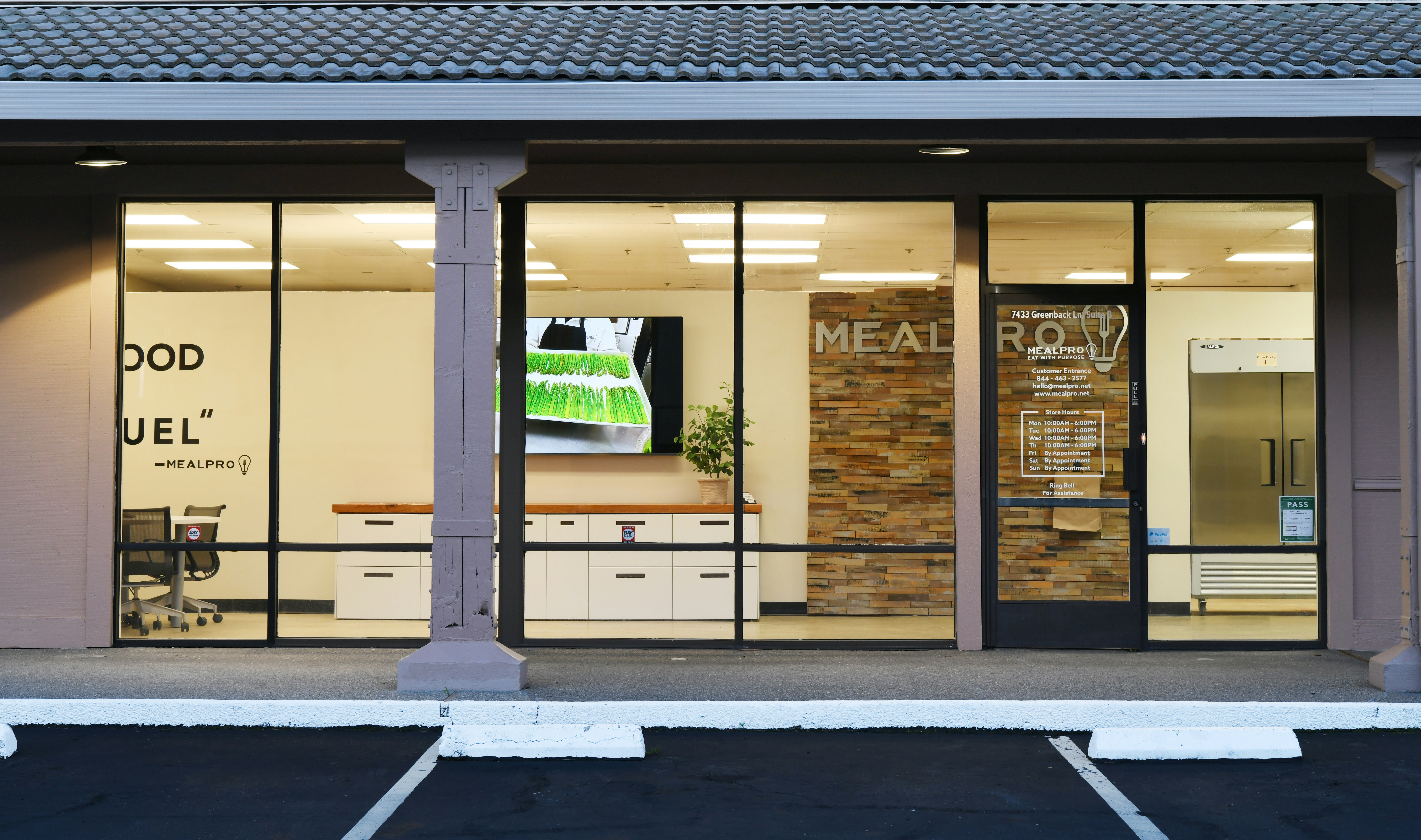Clean bright office storefront with large glass windows and professional supplies displayed