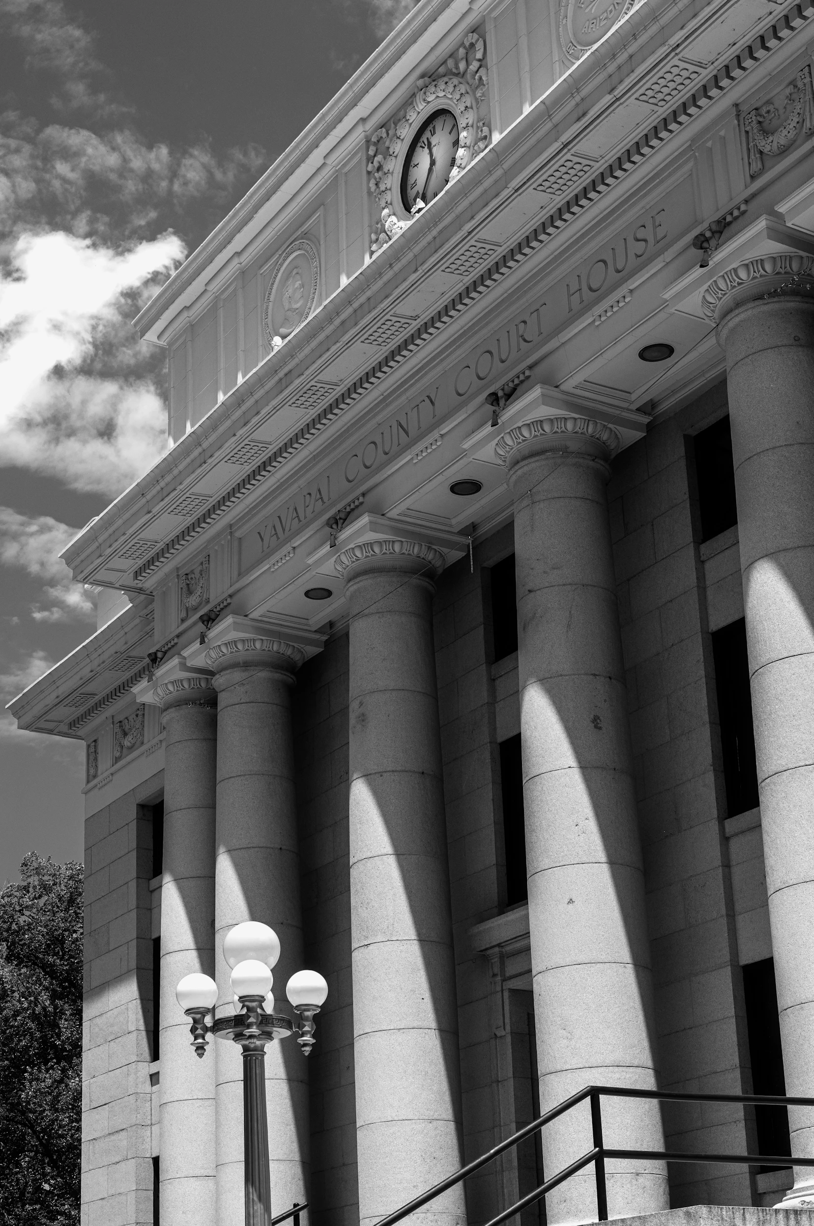 A county courthouse with columns and a clock tower