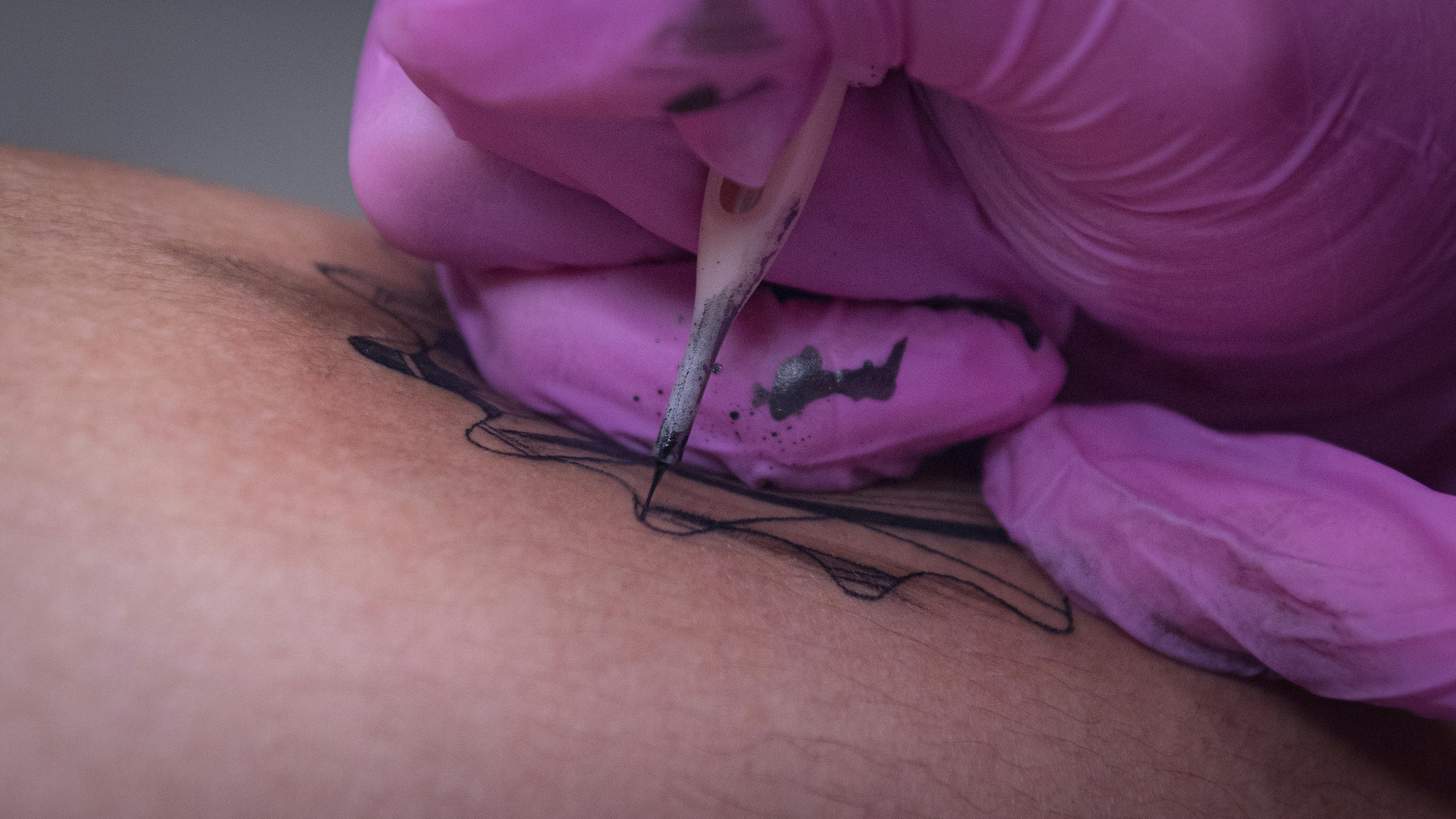 A close up of a person getting a tattoo