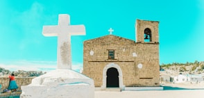 A church with a white cross on top of it