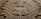 A stone carving of a face with many symbols on it