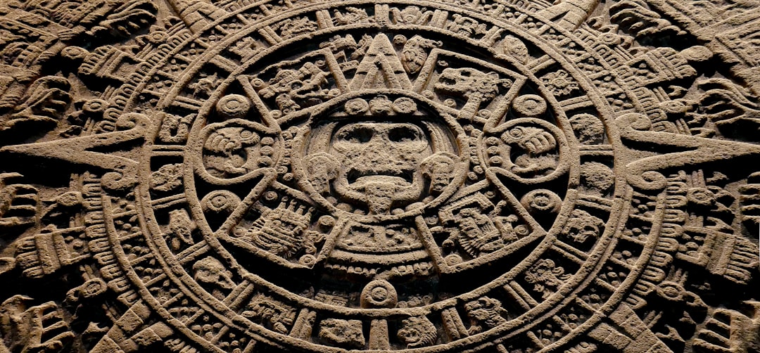 A stone carving of a face with many symbols on it, Use it wisely & say hello on instagram.com/srcharlss