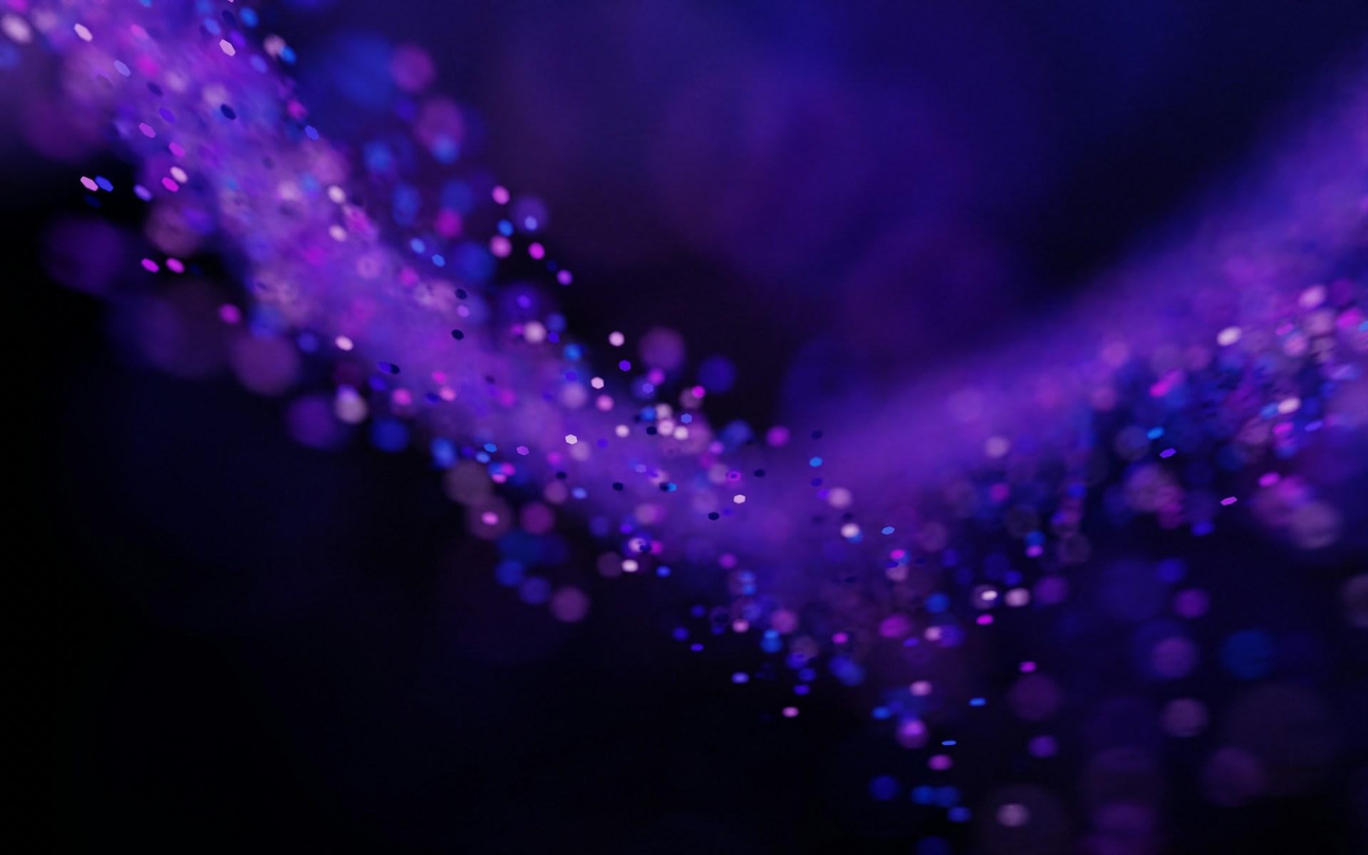 A blurry photo of a purple and black background