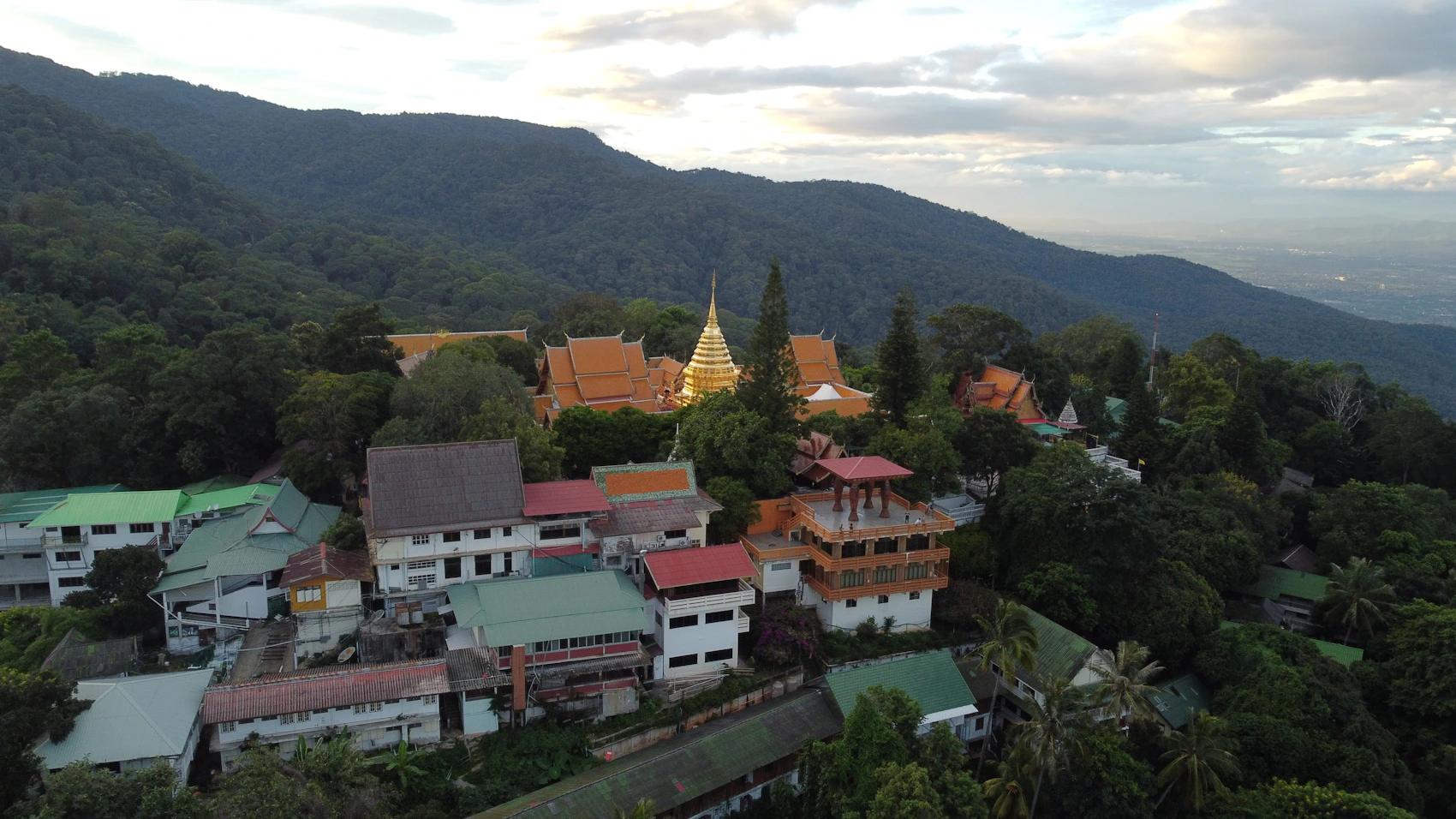 Aerial view of Doi Suthep temple and forested mountains in Chiang Mai, Thailand