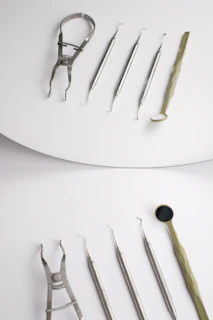A pair of surgical instruments sitting on top of a white surface