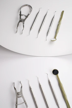 A pair of surgical instruments sitting on top of a white surface