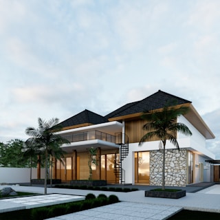 A house with a lot of windows and palm trees raga architect jasa gambar bangunan