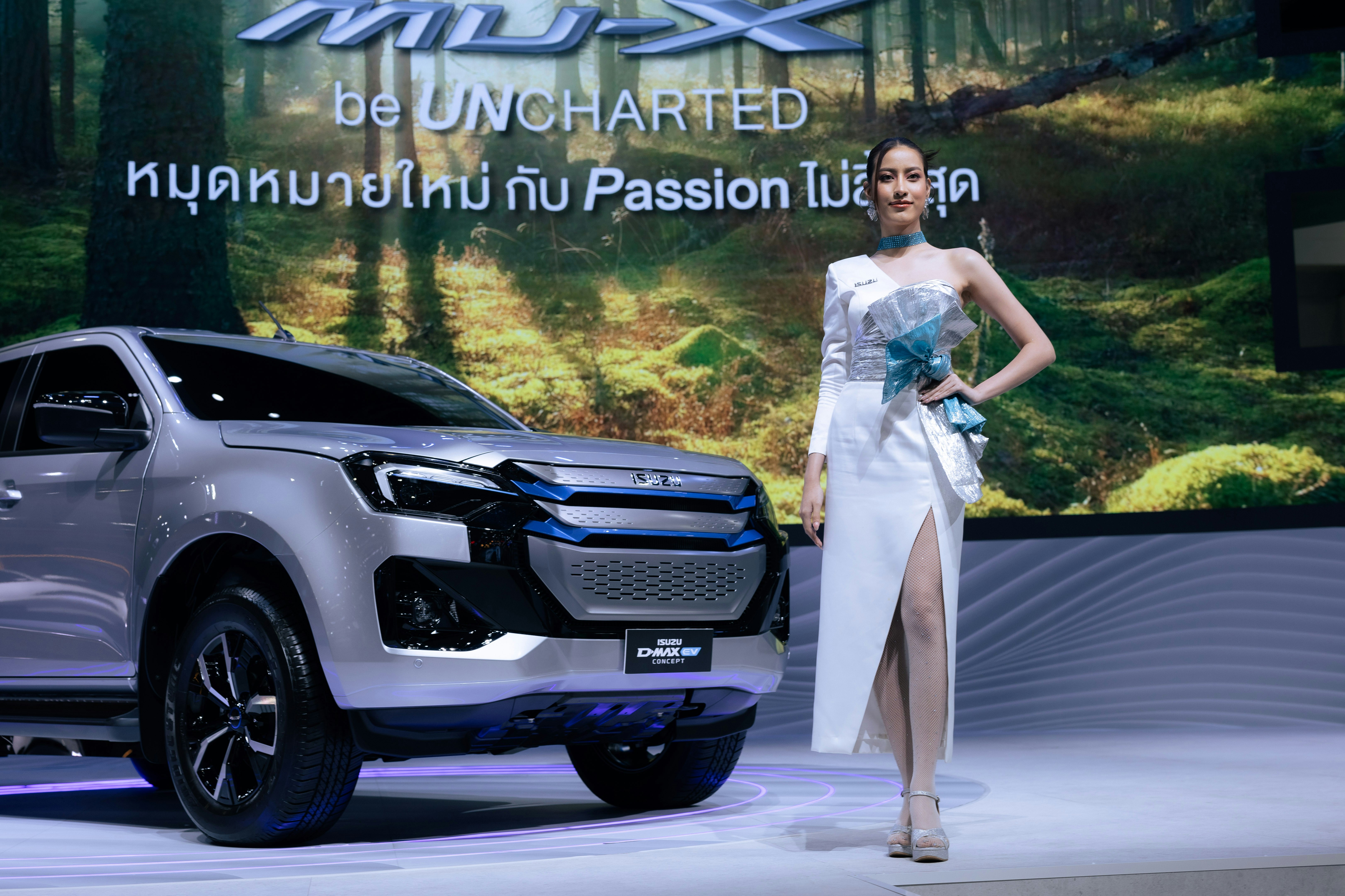 A woman standing next to a silver truck