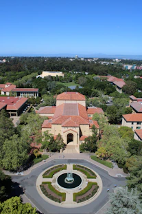 An aerial view of a campus with a fountain