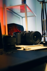 A camera sitting on top of a table next to a laptop