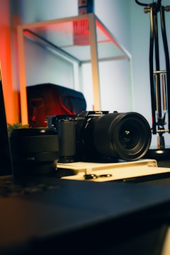A camera sitting on top of a table next to a laptop
