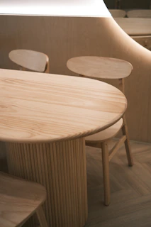 A wooden table and chairs in a room