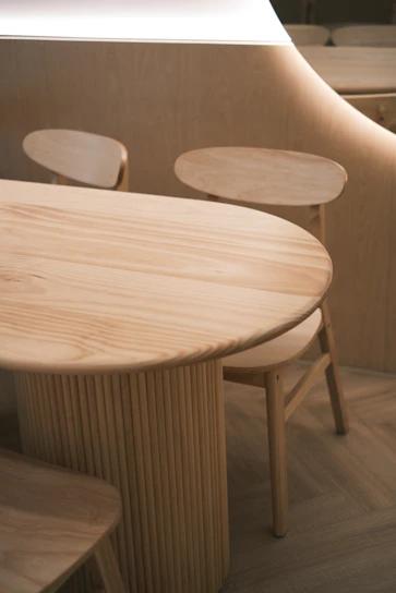 A wooden table and chairs in a room