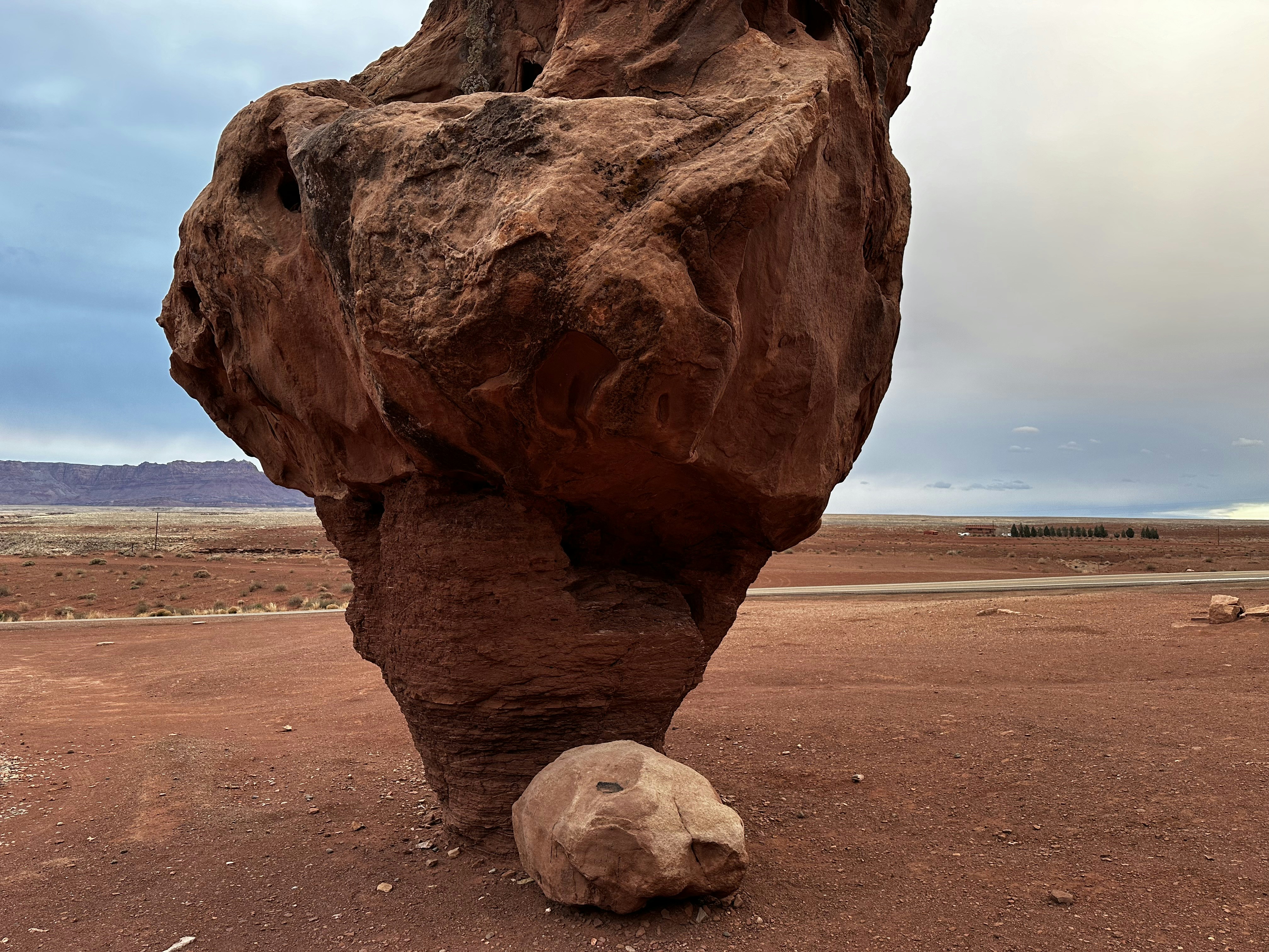 A large rock in the middle of a desert