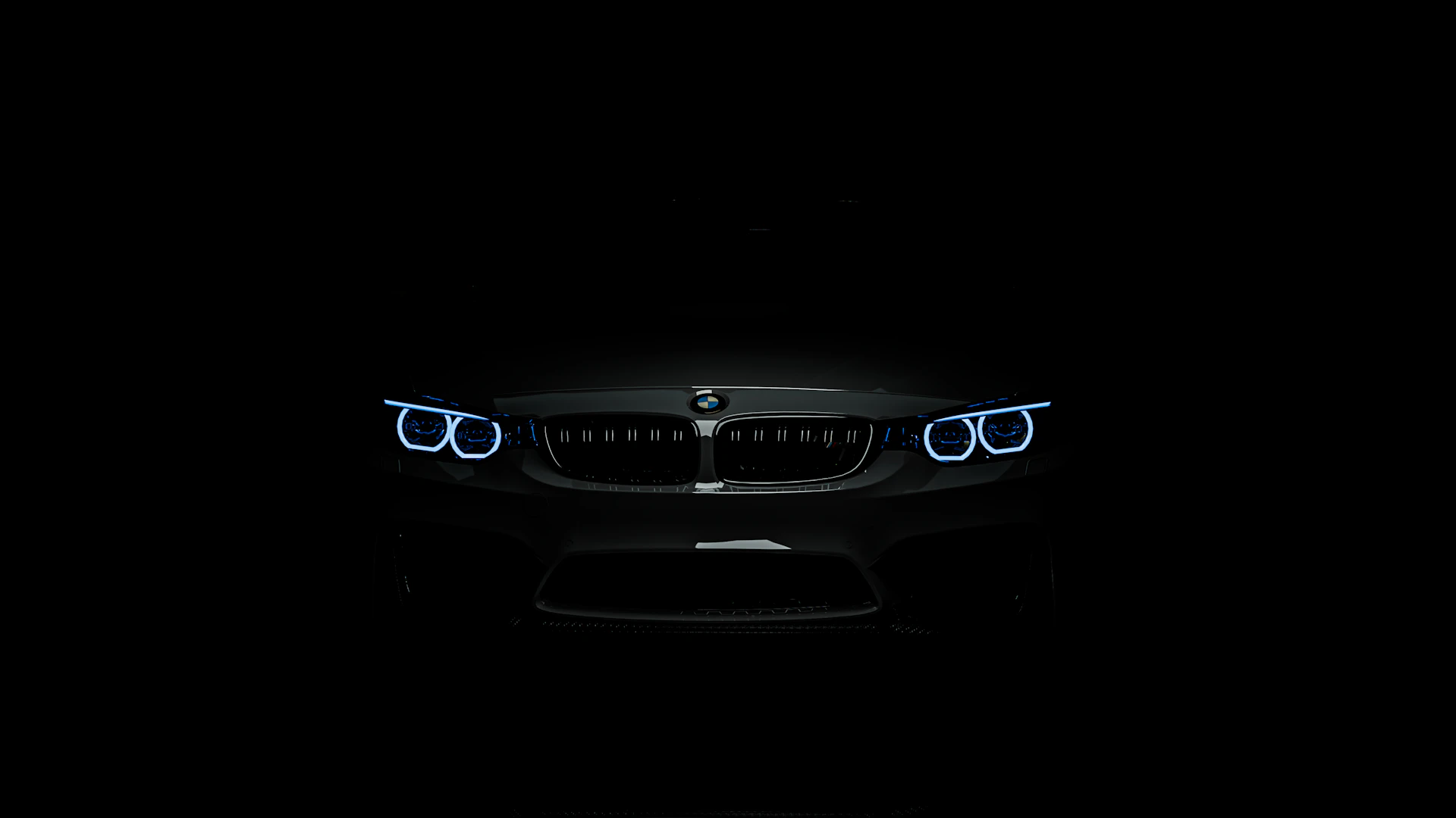 The front lights of a car in the dark