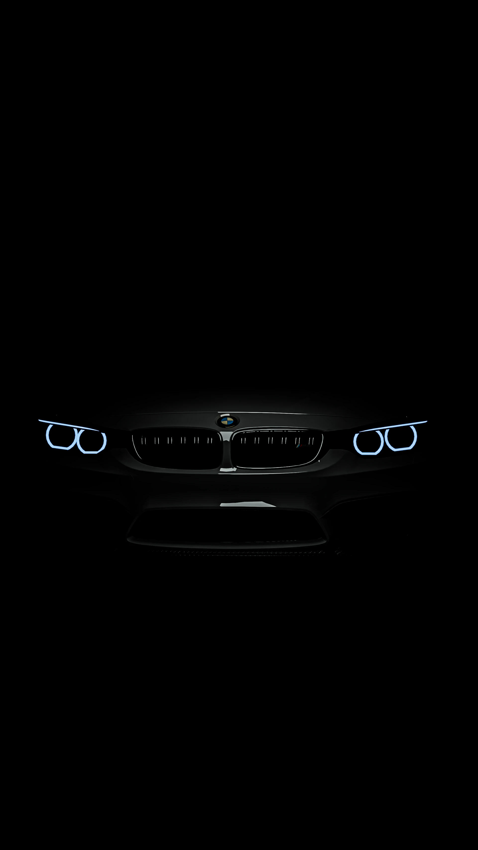 The front lights of a car in the dark