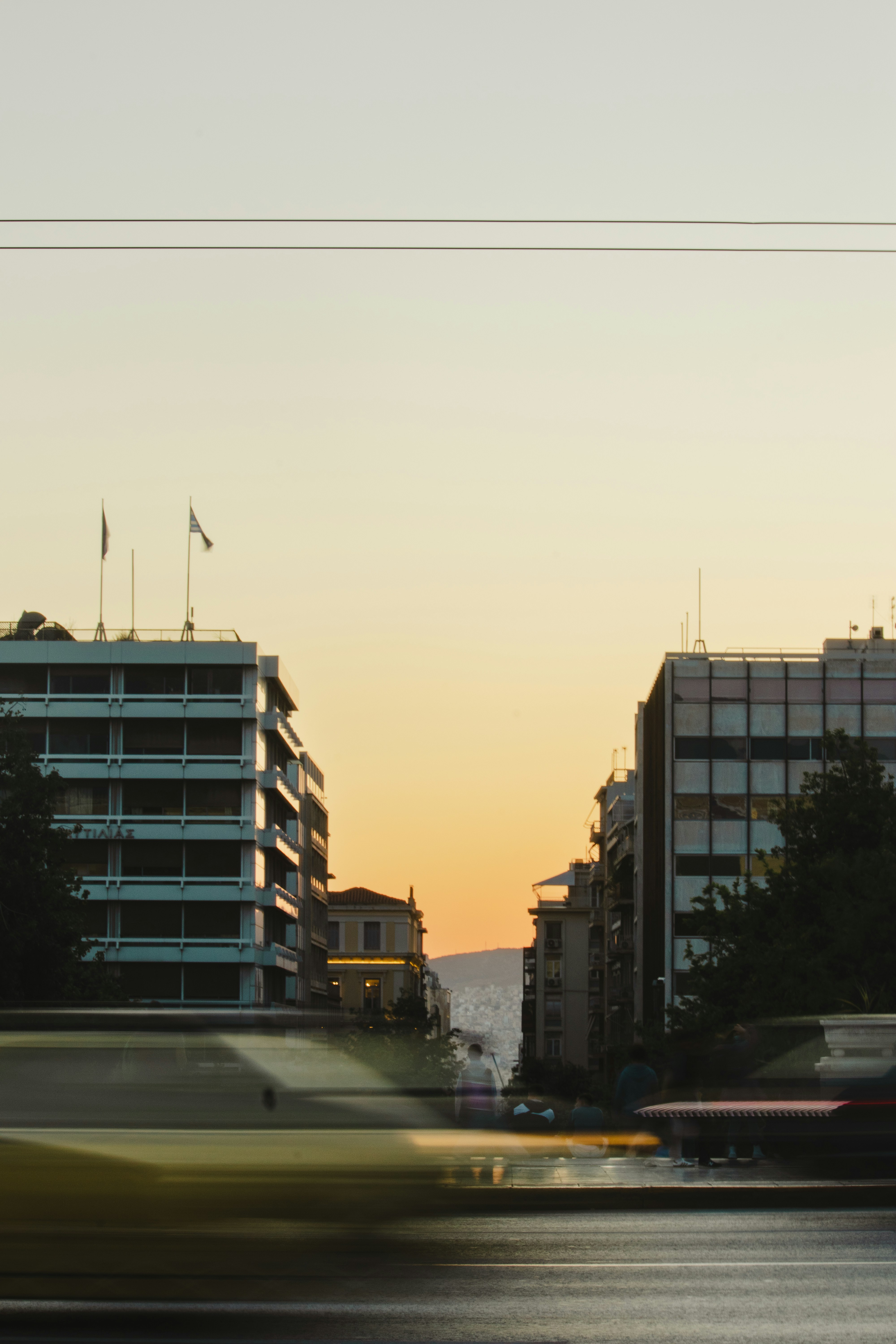 A traffic light on a pole in the middle of a city