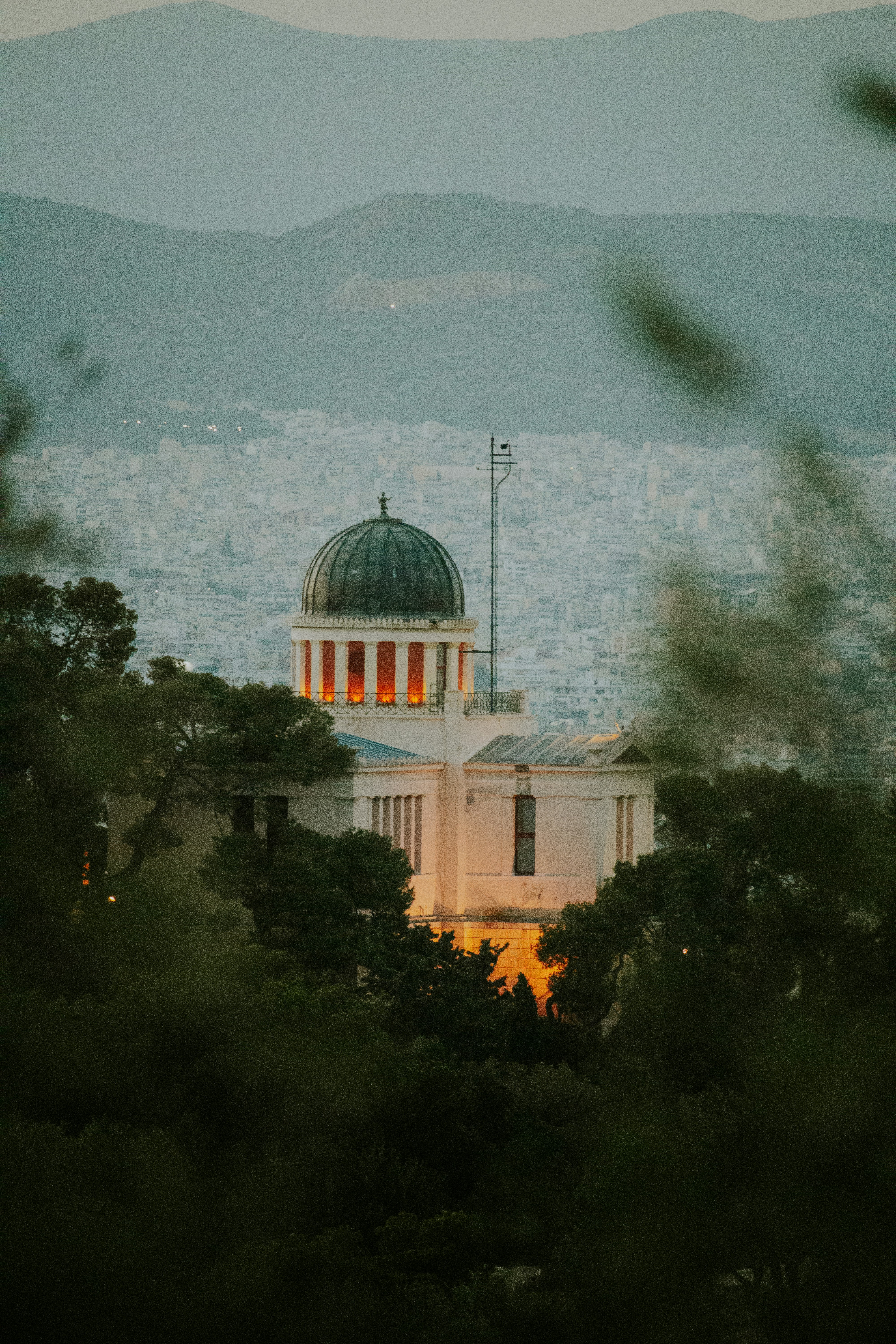 A building with a dome on top of it surrounded by trees