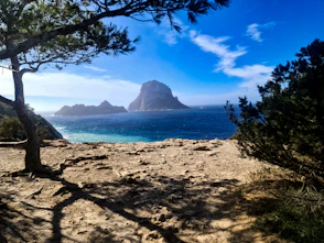 A scenic view of a beach with a mountain in the background