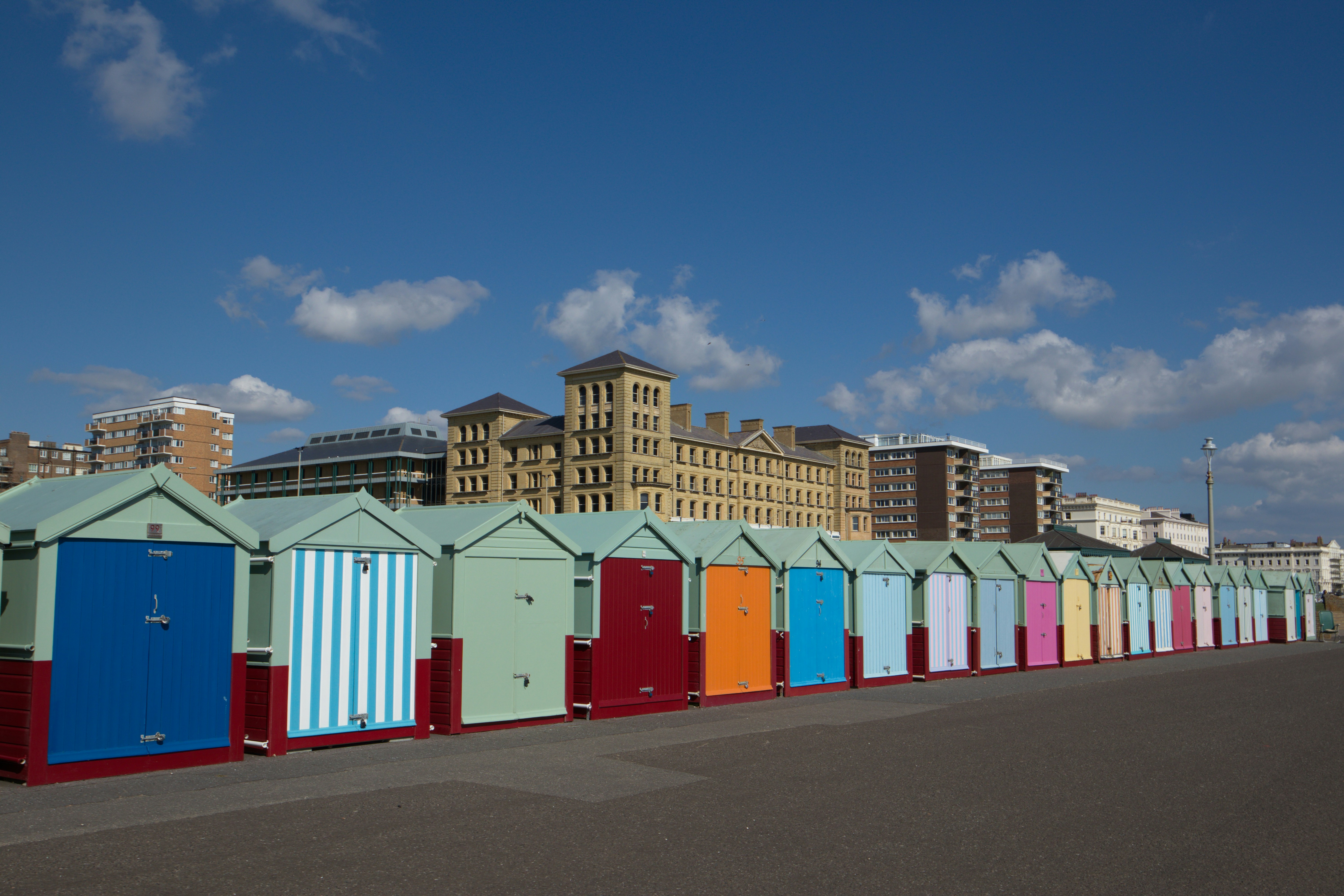 A row of beach huts sitting next to each other