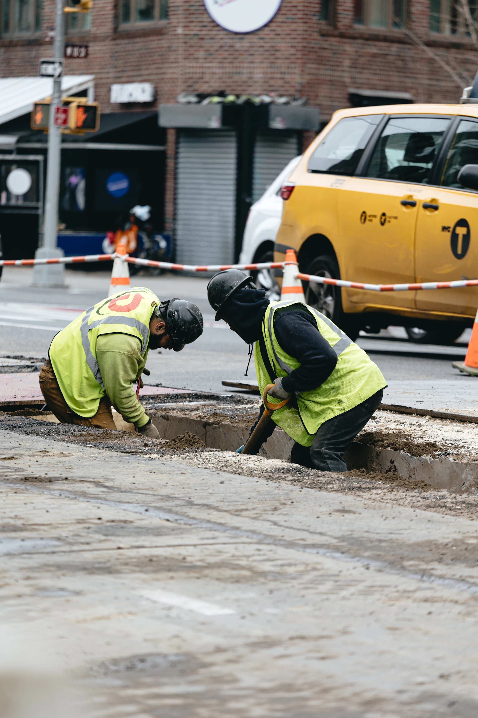 A couple of men working on a street