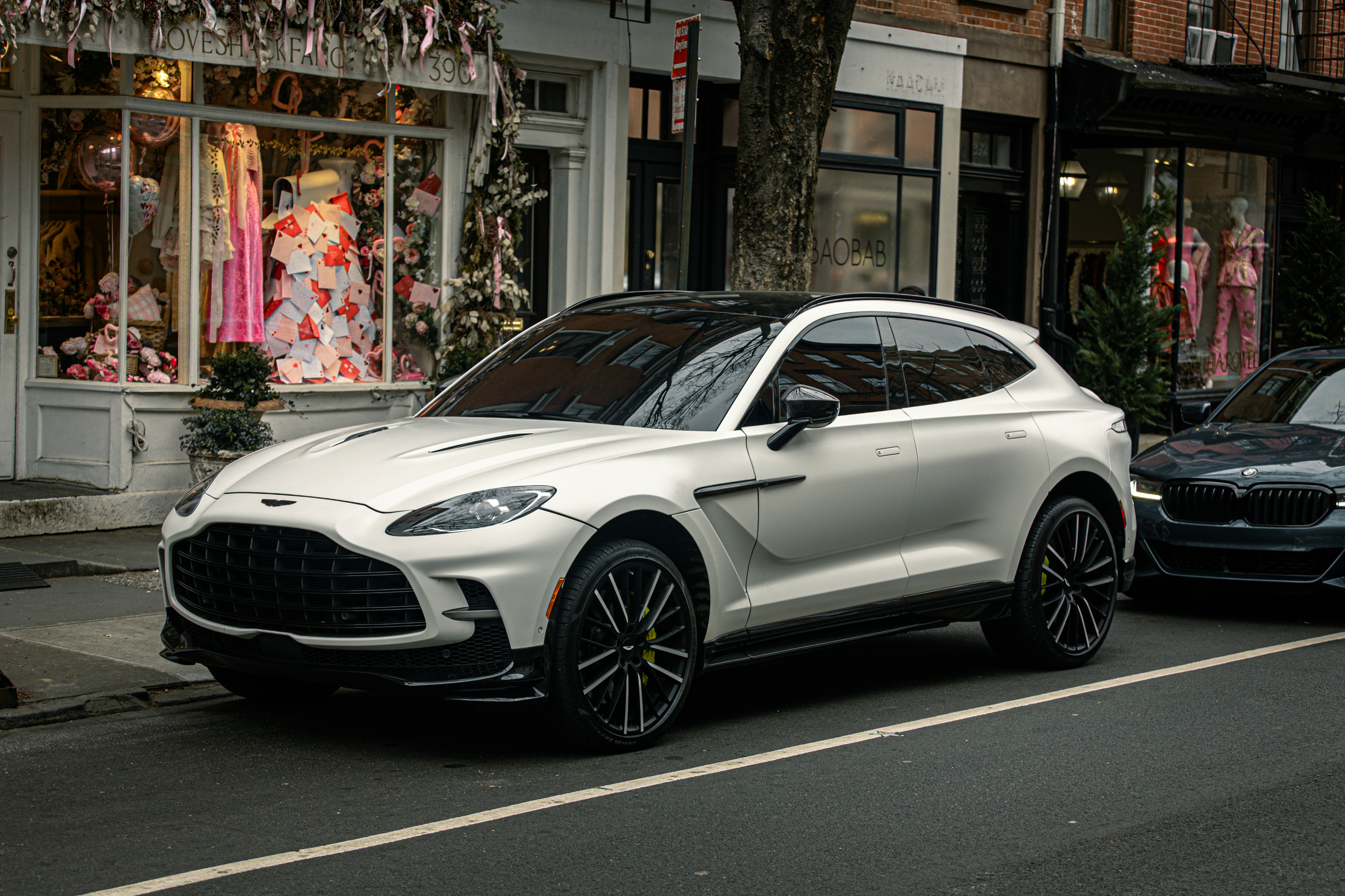 A white car parked on the side of the road