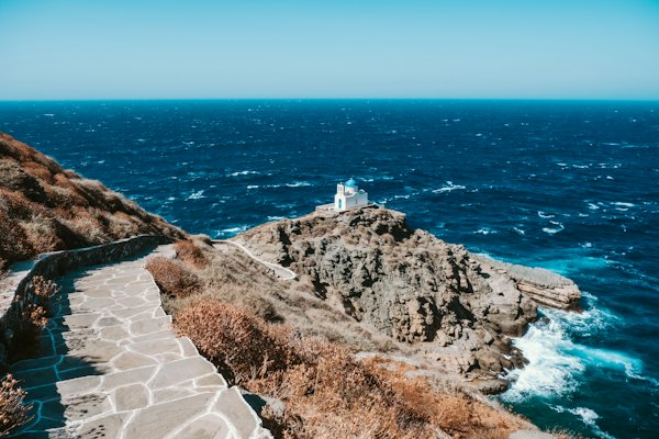 The stone path out to the white chapel of the Seven Martyrs below Kastro — Sifnos, Greece
