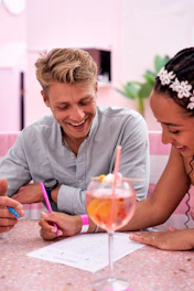A man and a woman sitting at a table with drinks