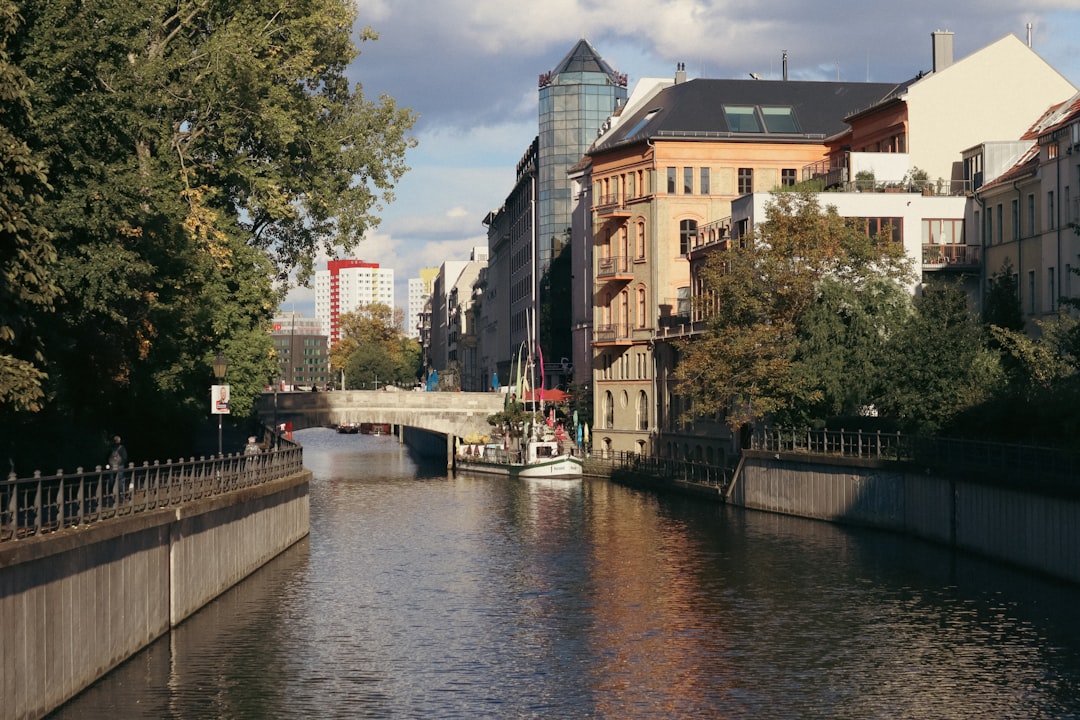 A river running through a city next to tall buildings,