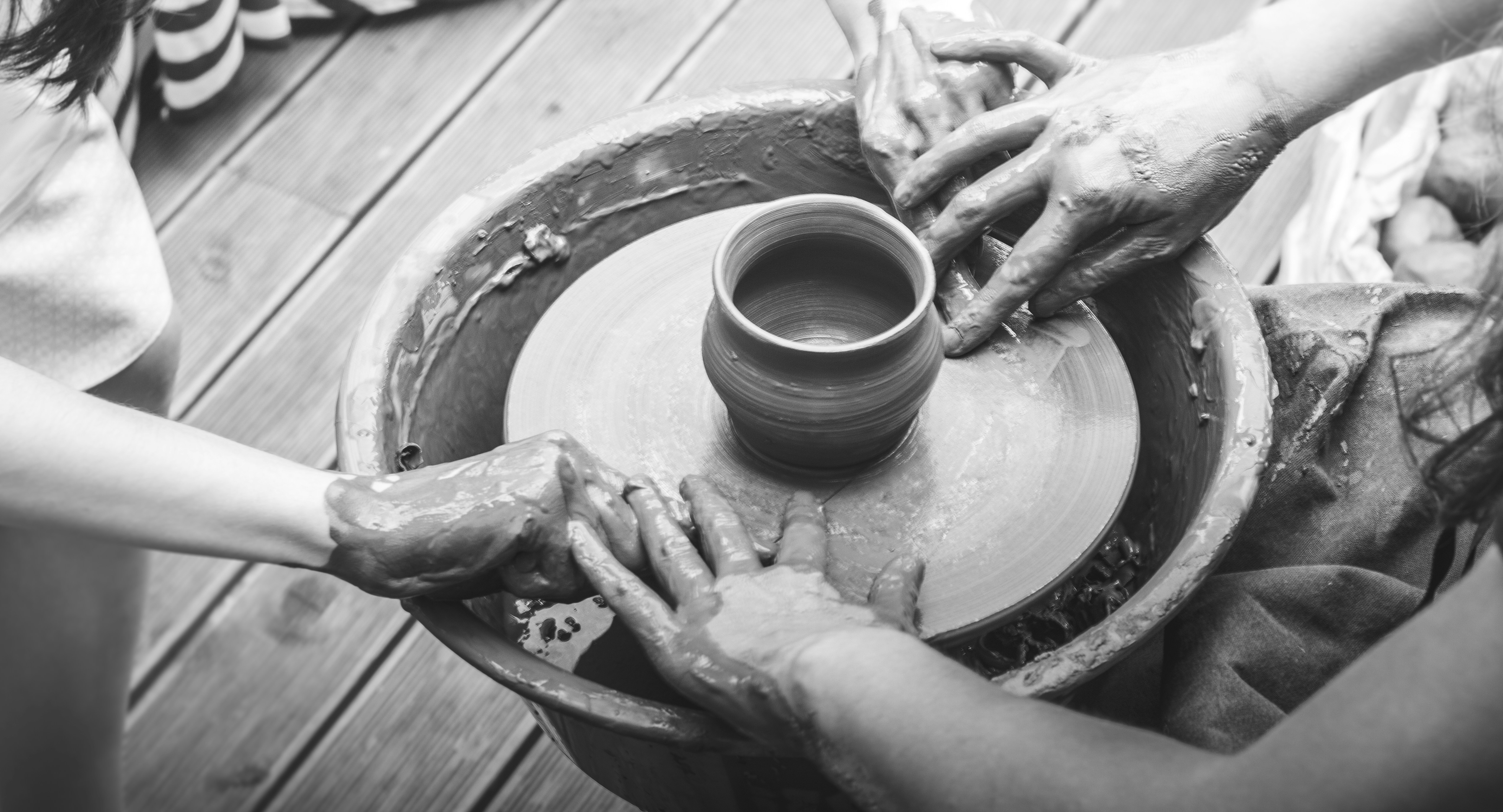 Clay pot being removed from wheel