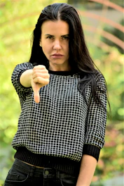 A woman pointing a gun at the camera