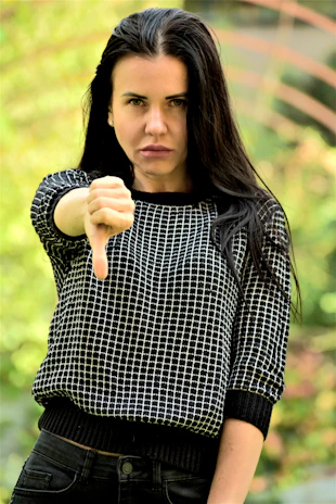 A woman pointing a gun at the camera