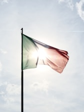 A flag flying in the wind on a sunny day