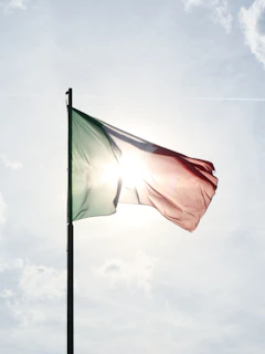 A flag flying in the wind on a sunny day
