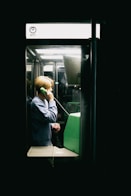 A man talking on a cell phone while riding a bus