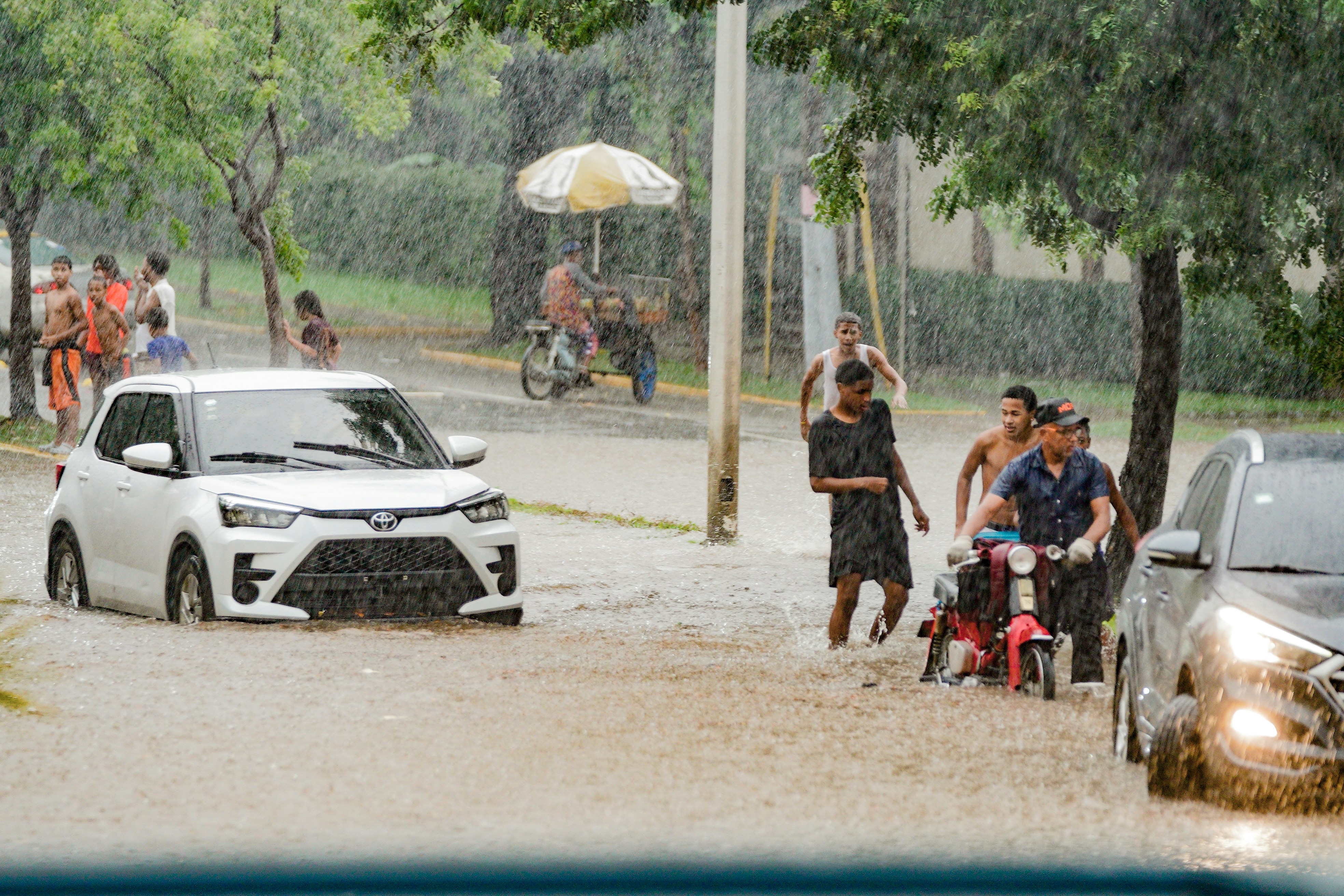 A group of people standing in a flooded street