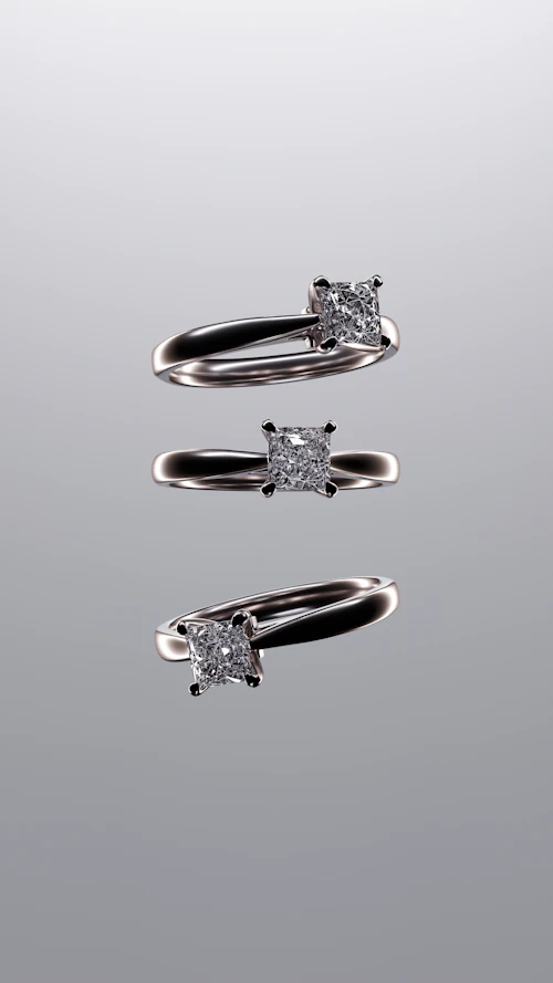 Three silver solitaire rings