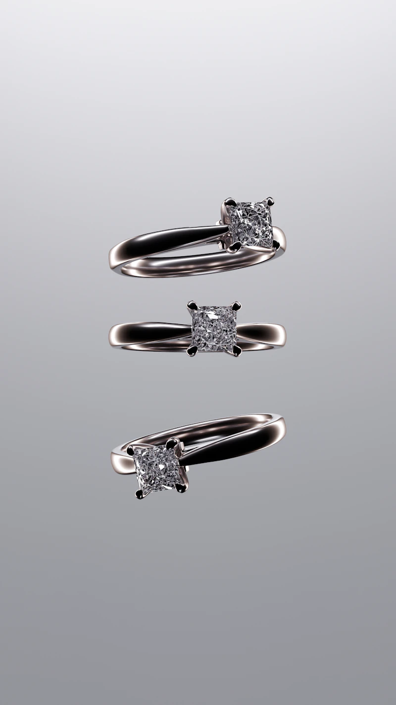 Three silver solitaire rings with square-cut stones on a soft grey gradient