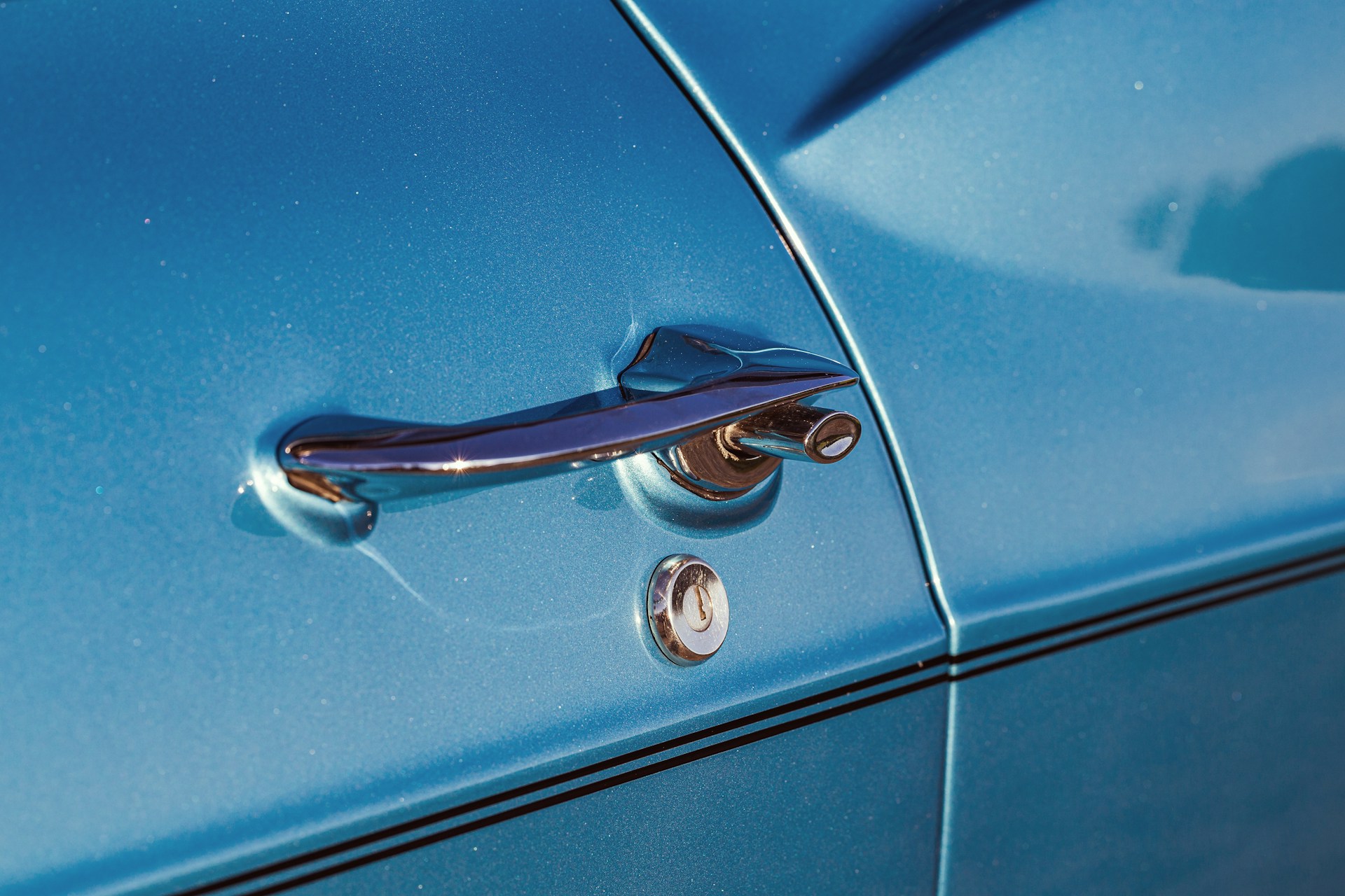 A close up of a blue car door handle