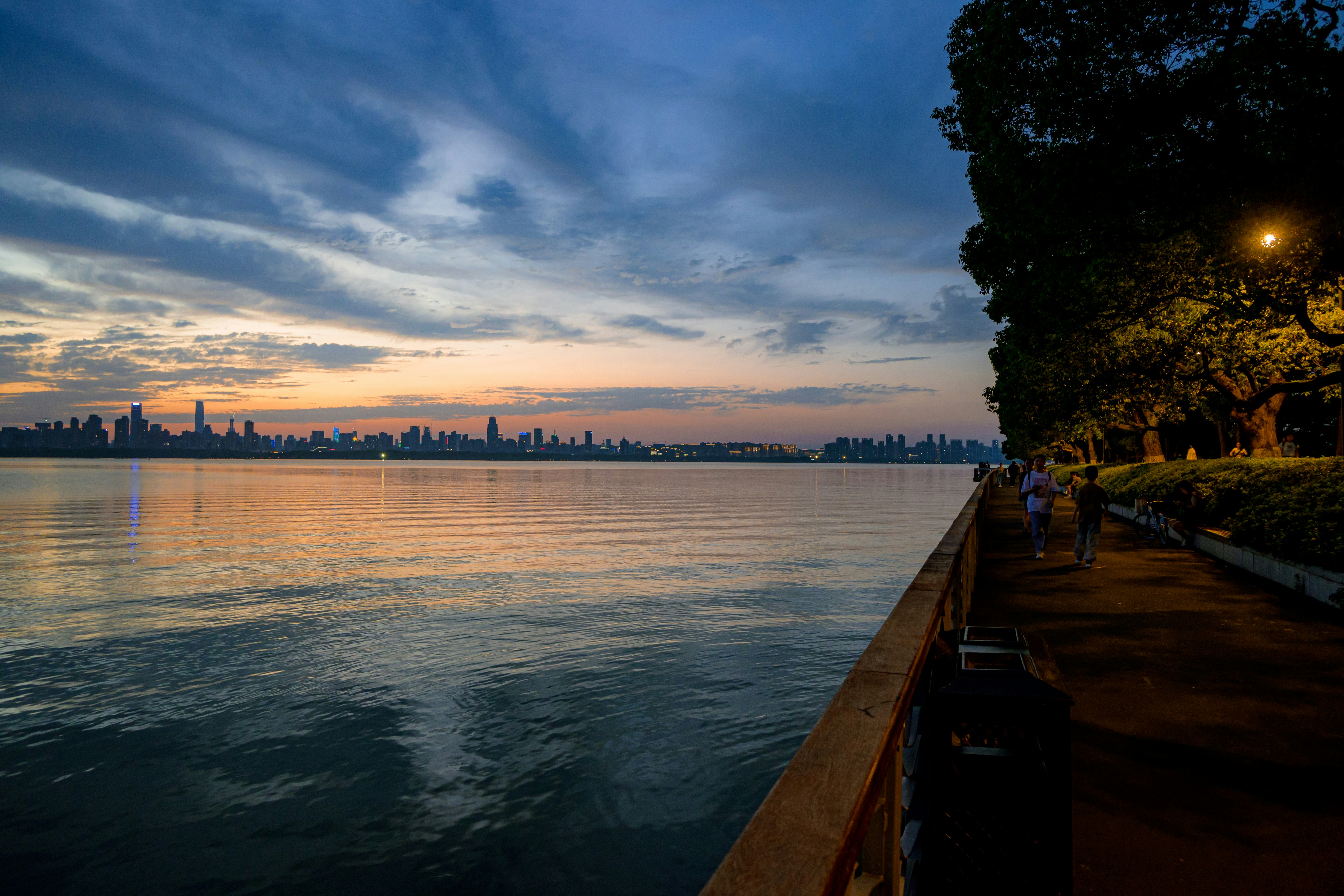 Luxury rooftop lounge at dusk overlooking Chicago skyline and lake - Chicago luxury apartment listings