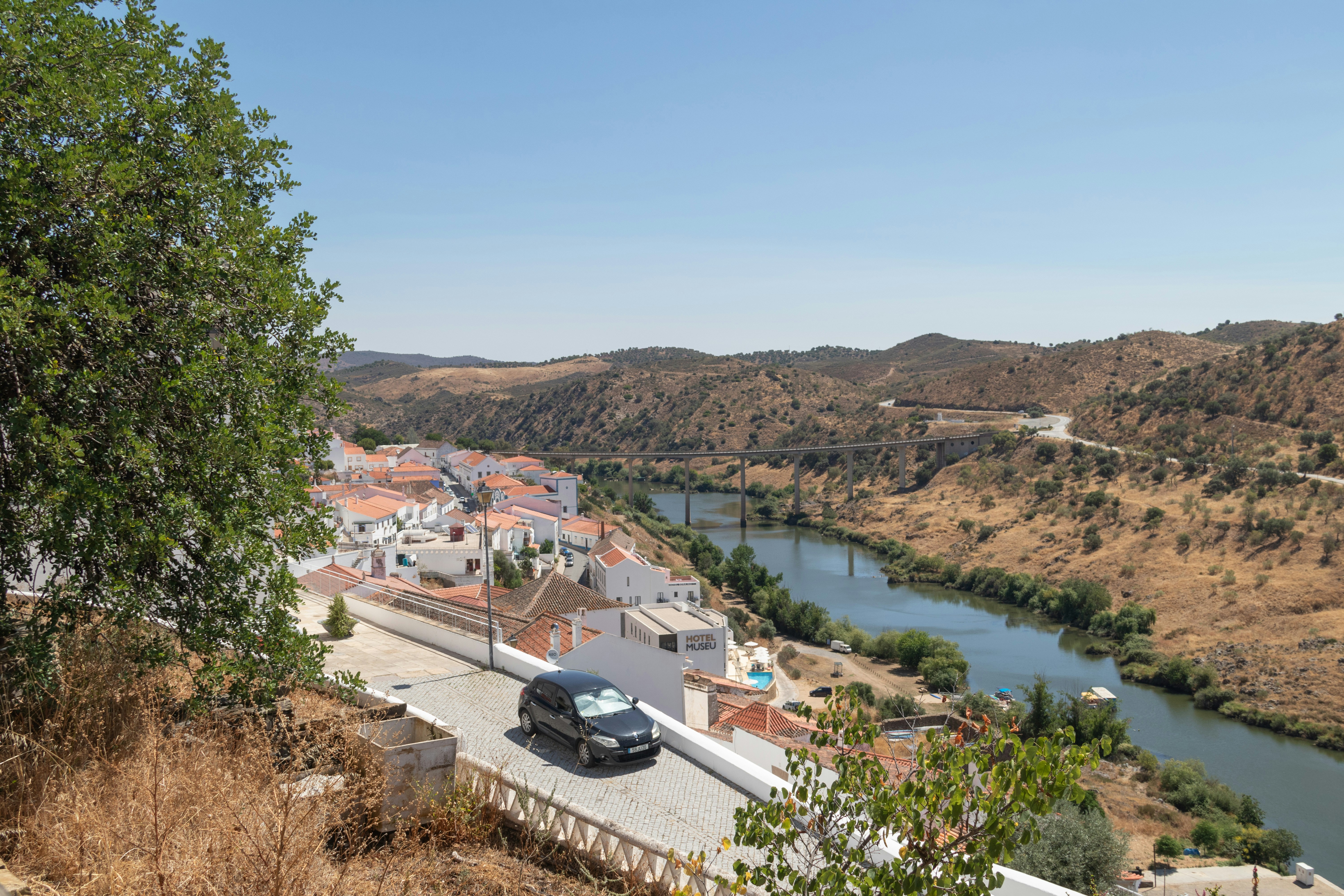 A car driving down a road next to a river