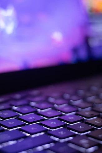 A close up of a laptop keyboard with a blurry background