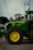 A green tractor parked on a brick road
