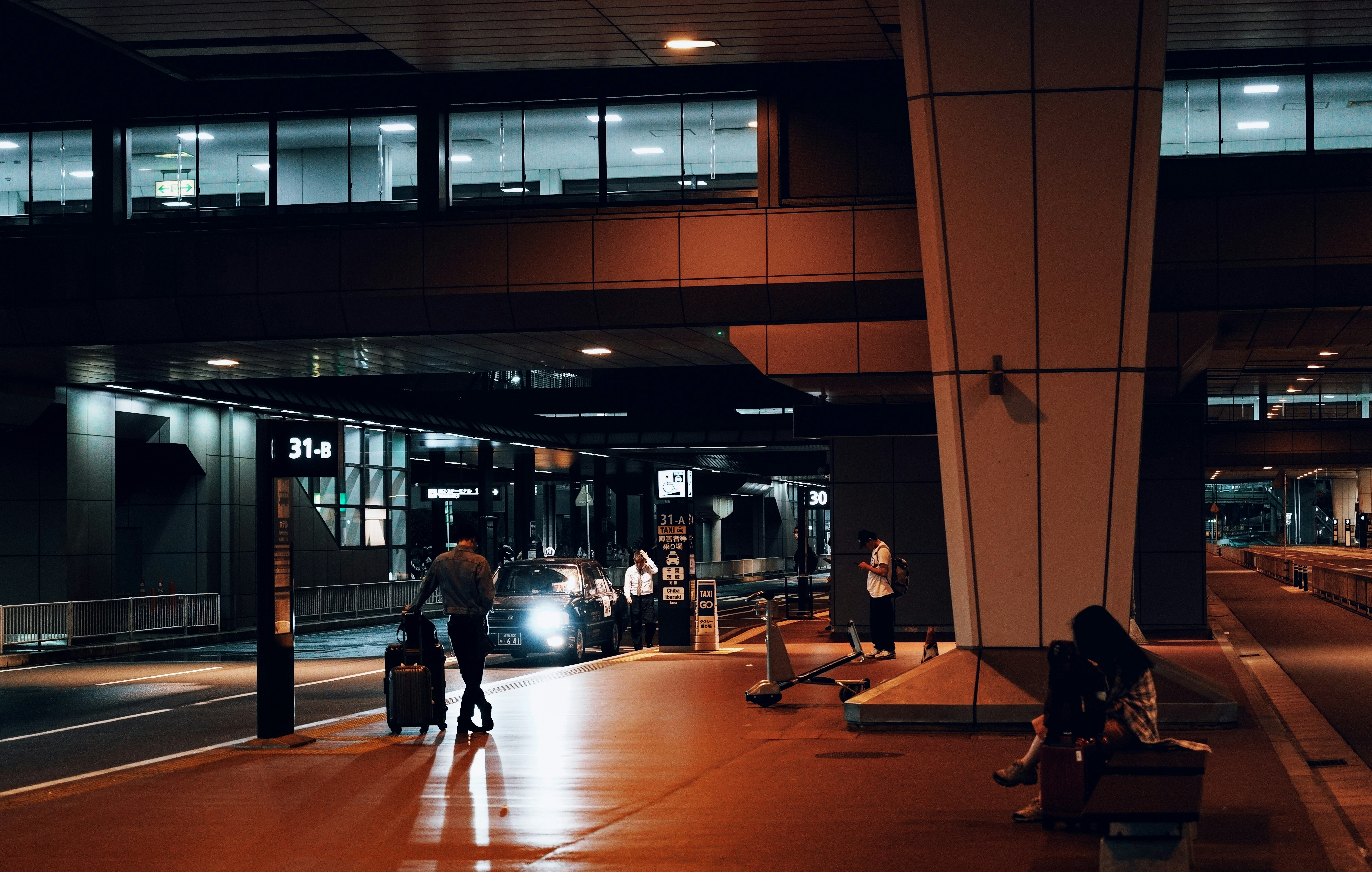 A man riding a skateboard down a street next to a tall building
