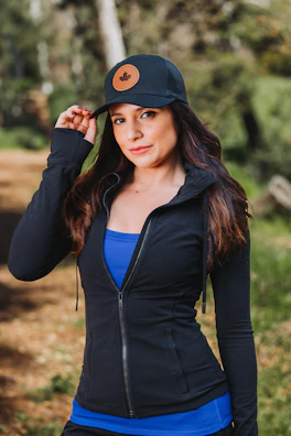 A woman wearing a black jacket and a hat