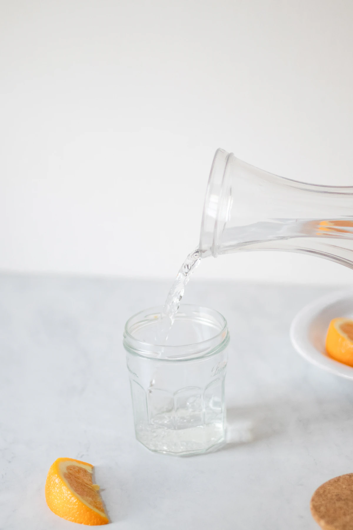 Wasser wird in ein Glas gegossen als Symbol für Flüssigkeitshaushalt nach dem Rauchstopp