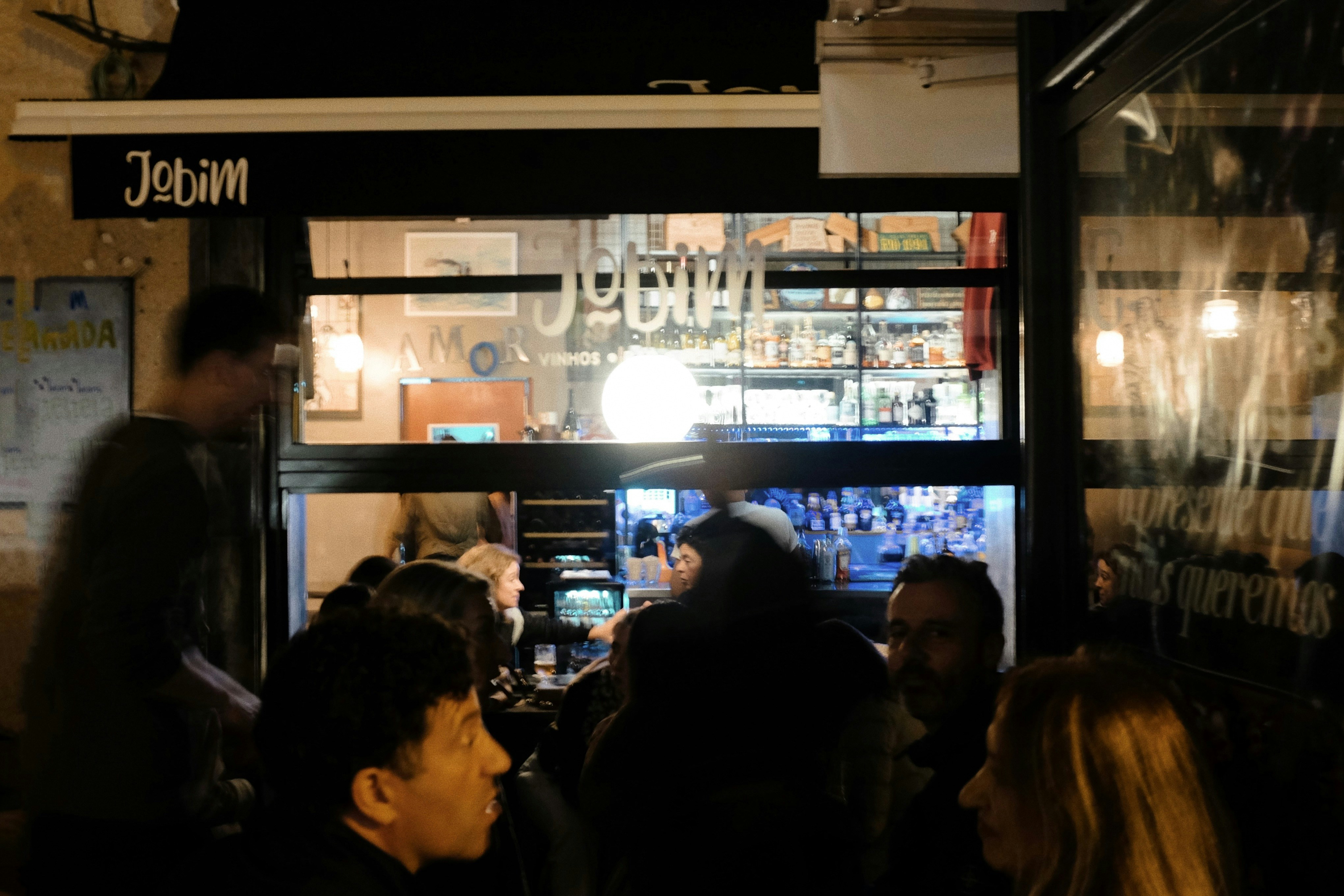 A group of people standing in front of a store